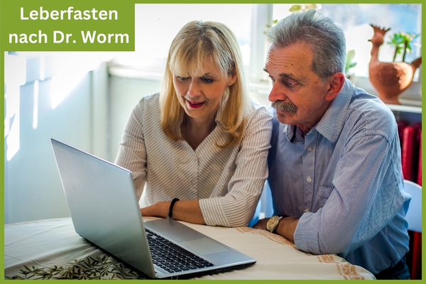 Leberfasten. Frau und Mann sitzen vor einem Laptop und schauen ein Webinar.